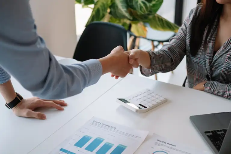 Two people shake hands