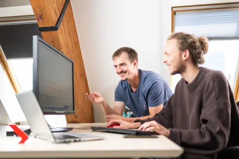 Zwei Enotrac Mitarbeitende bei der Arbeit im Büro