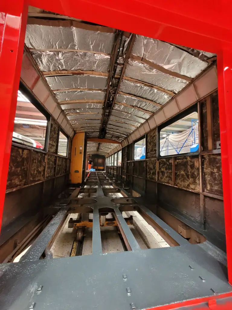 Stripped interior of a railway carriage with the train's metal frame exposed