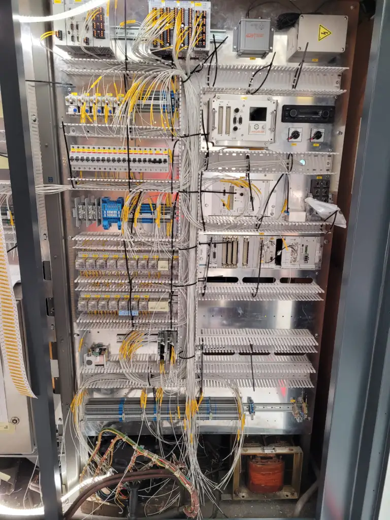 Electrical cabinet inside a train containing various electronic modules.