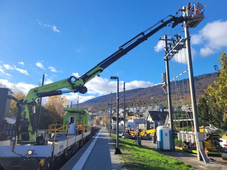 Installation work on a new control post using a crane mounted on a train