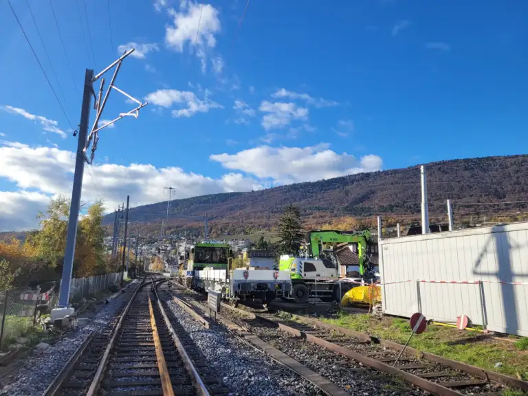 A construction train on a single track. The overhead lines and masts have not yet been installed